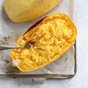 Spaghetti squash that has been halved, roasted and fluffed with a fork